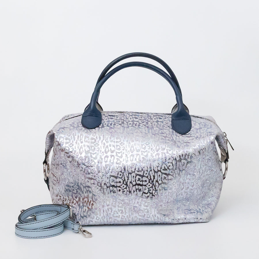 Vera handbag in Moonlit Riviera featuring side straps with silver o-ring clasp and structured top handles and extra strap