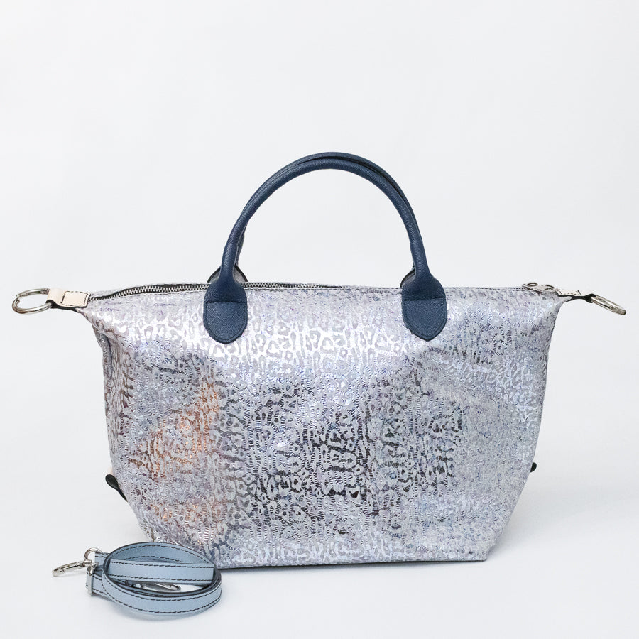 Expanded Vera handbag in Moonlit Riviera featuring iridescent silver cheetah printed Italian leather and blue structured top handles