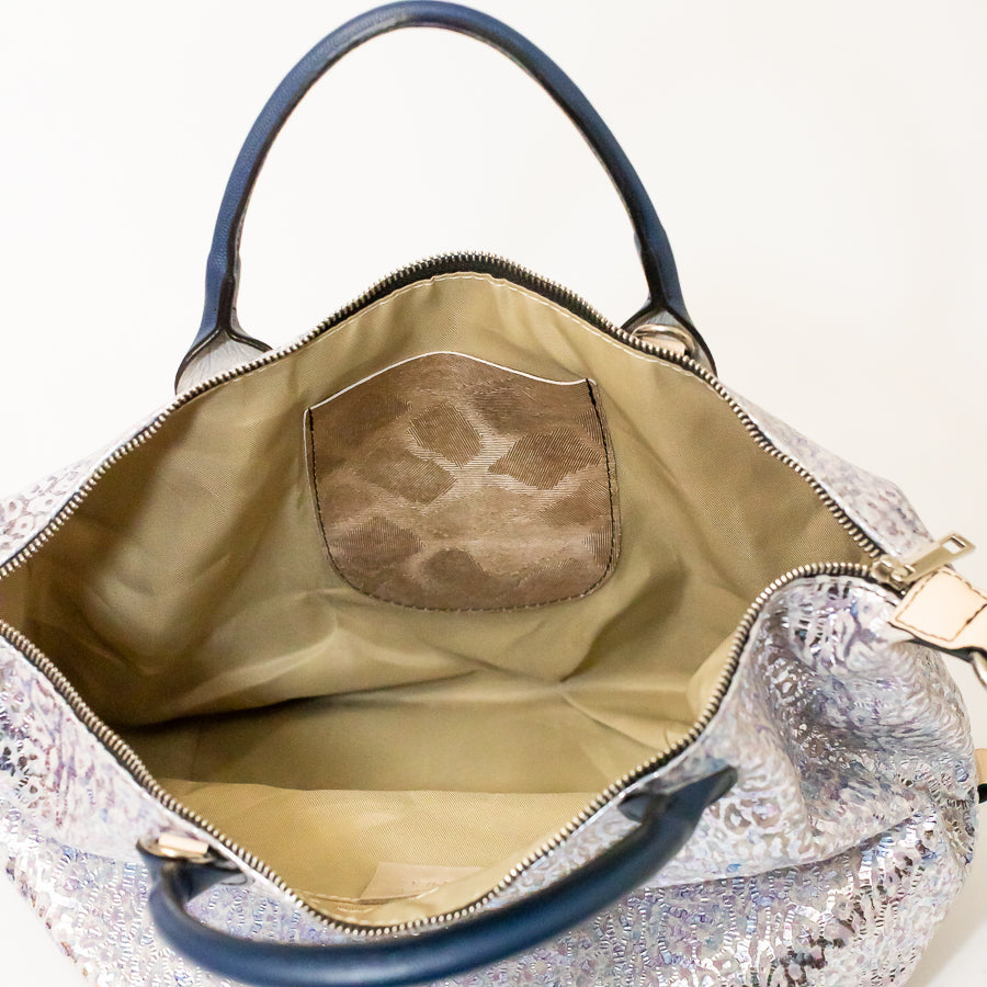 Interior image of Vera handbag in Moonlit Riviera featuring Italian leather interior pocket and gold zipper hardware
