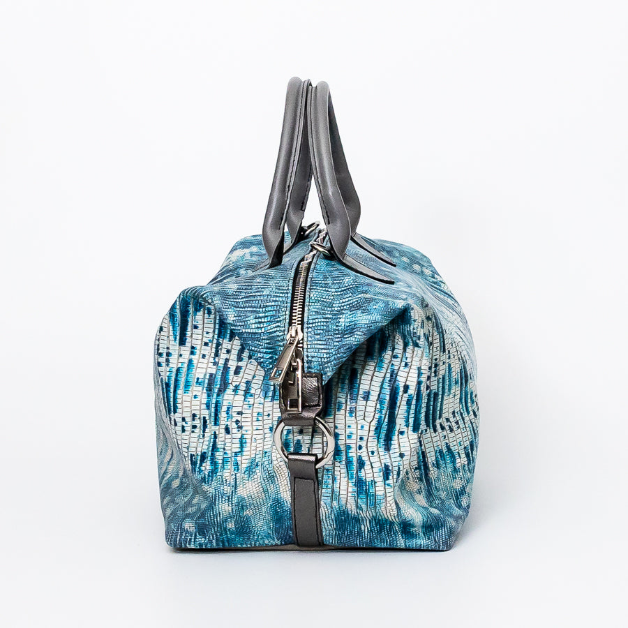 Side image of Vera handbag in Amalfi Coast featuring o-ring clasps and structured handles