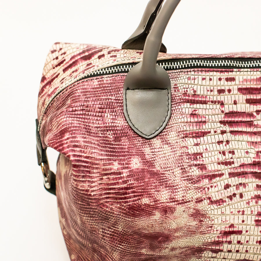 Close-up image of Vera handbag in Chianti Sunset featuring o-ring secured straps and silver zipper hardware
