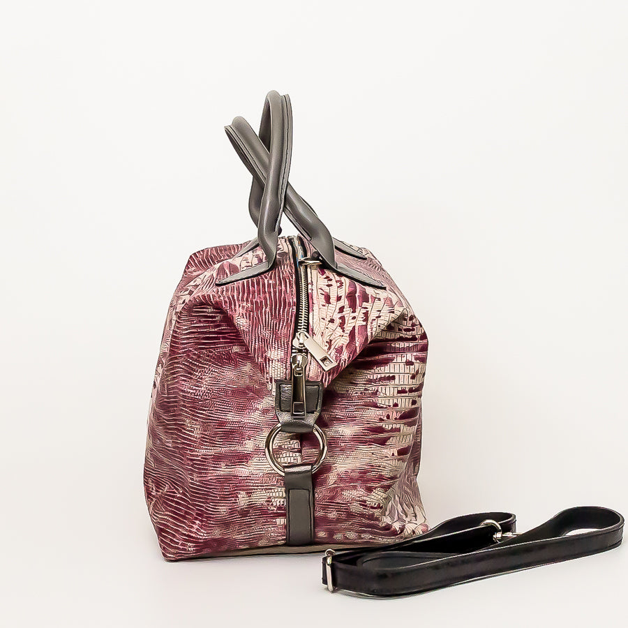 Side image of Vera handbag in Chianti sunset featuring silver o-ring secured straps and silver zipper hardware