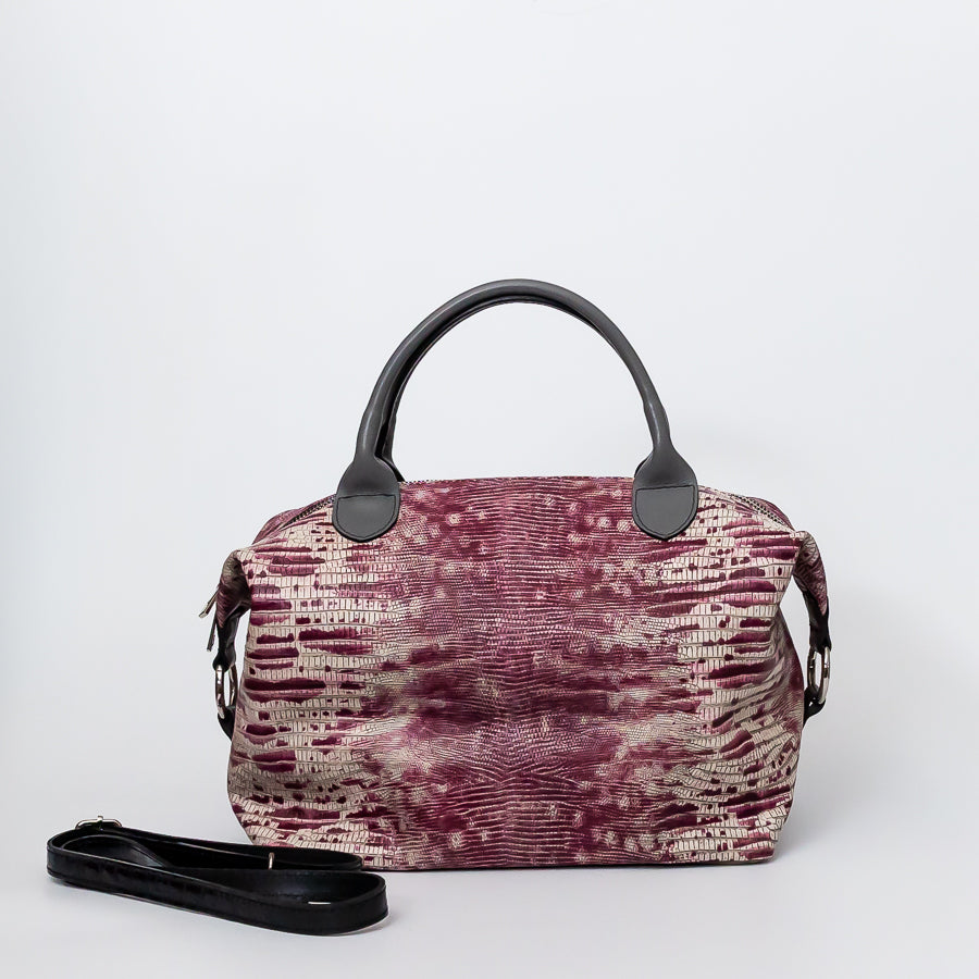 Vera handbag in Chianti Sunset featuring side straps with silver o-ring clasp and structured top handles and extra strap