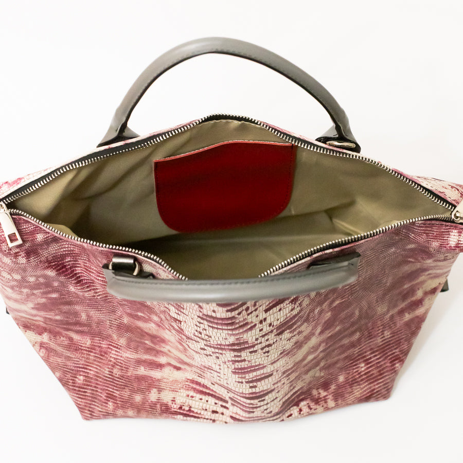 Interior image of Vera handbag in Chianti Sunset featuring red Italian leather interior pocket and silver zipper hardware