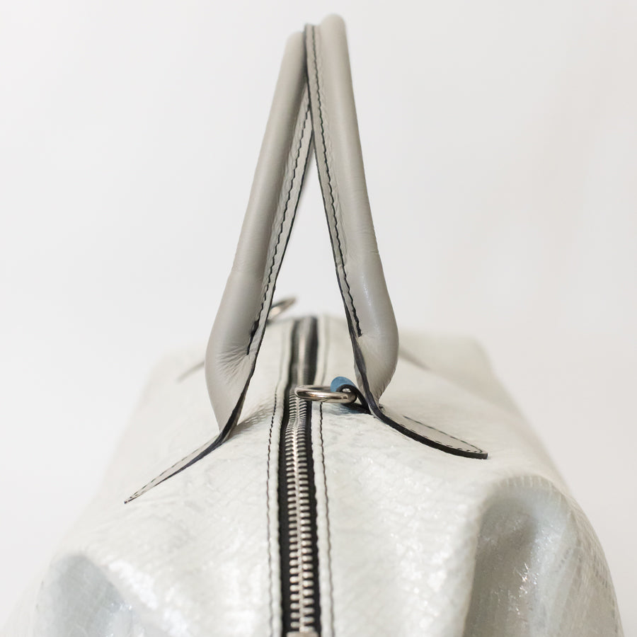 Close-up image of Vera handbag in Winter Lace featuring structured top handles and silver hardware
